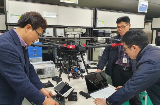 caption ETRI researchers inspecting hyperspectral camera drone